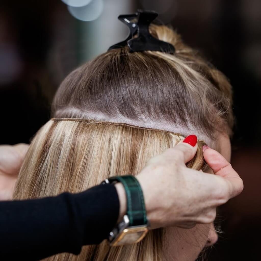 Applying clip in hair extensions