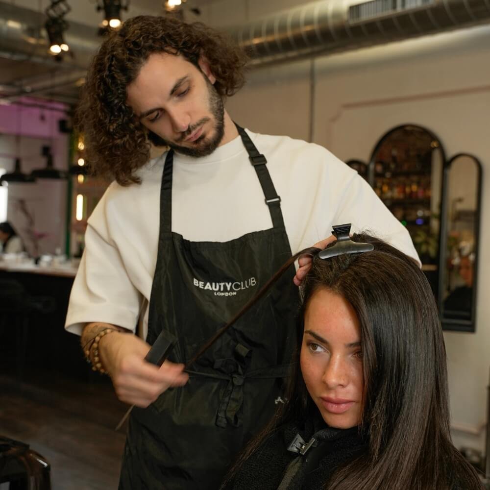 Hair Colour Expert assesing hair for Balayage